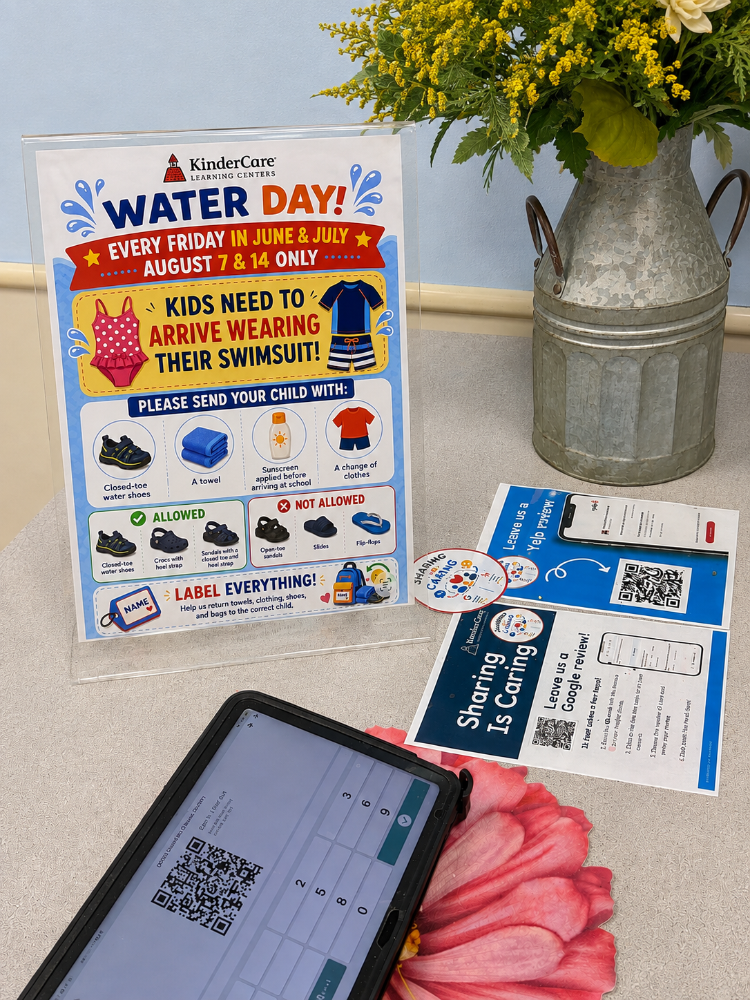 Water Day family information sign displayed at the front desk alongside review cards